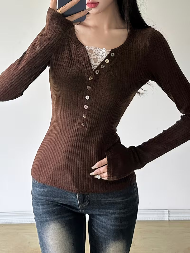 a brown ribbed sweater with button details and blue jeans.